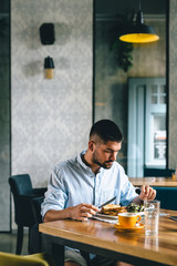 Fototapeta na wymiar man eating breakfast in cafe