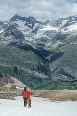 Fototapeta premium active senior woman, riding her electric mountainbike below the famous Matterhorn in Zermatt, Wallis,Switzerland