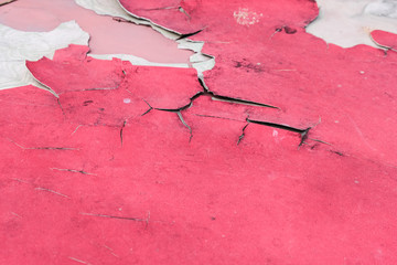 Crack red metal, peeling paint color, damage of sun burn on old car