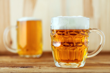 Two full jugs of beer on bar counter