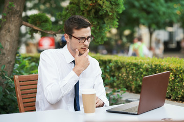 businessman working on his laptop in park