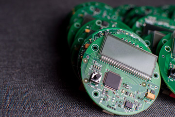 round electronic boards with display, microchip and processor, many clock components, close-up
