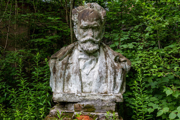 Old damaged bust to Russian composer Pyotr Ilyich Tchaikovsky (Chaikovskiy) on the territory of an abandoned sanatorium