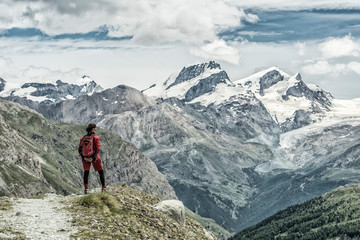 Fototapeta na wymiar young woman, hiking on the moraine above Zmutt glacier near Zermatt, Cantone Valais, Wallis, Switzerland