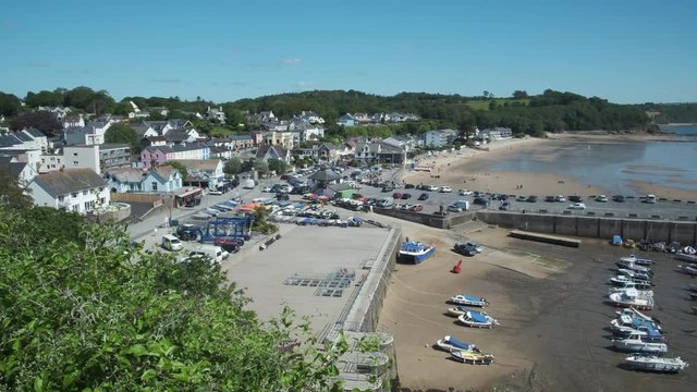 Panning overview of boats and harbour at Saundersfoot Pembrokeshire Wales   