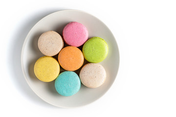 Fototapeta na wymiar Macaroons on a plate on a white background. Top view. Place for text