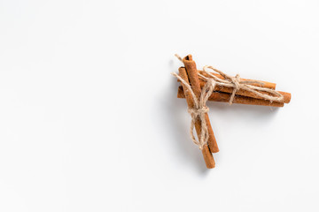 Cinnamon sticks on white background with place for text