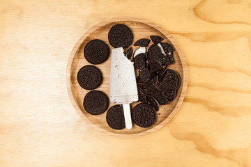 Ice cream - tasty and refreshing popsicle flavored cookies and cream, photo on wooden background, photo on wooden background