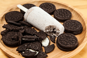 Ice cream - tasty and refreshing popsicle flavored cookies and cream, photo on wooden background, photo on wooden background
