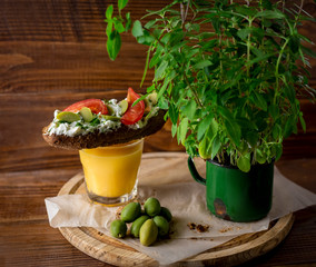 Bruschetta with cheese and olives on a wooden table