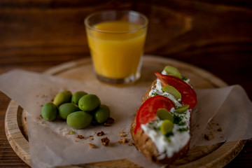 Bruschetta with cheese and olives on a wooden table