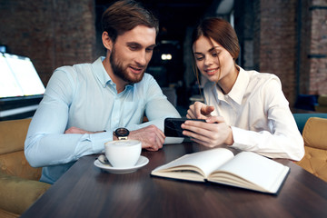man and woman working in office