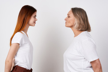 An elderly woman and granddaughter are standing nearby