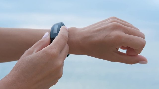 Smart watch on a female hand. Fitness bracelet on the female's hand.