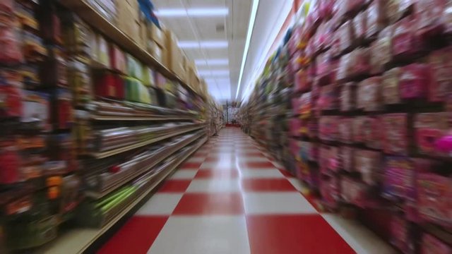 At the supermarket store pov action camera motion, through row section of the shop and different items merchandise. Front view shot. 4k.