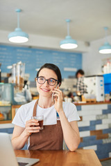 Barista makes a new application for a coffee shop on the phone