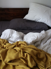 Fototapeta na wymiar Cozy bed with wooden headboard background 