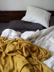 Cosy bed in the morning with sheets and blanket