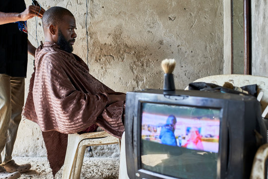 Man at barber shop looking at mirror