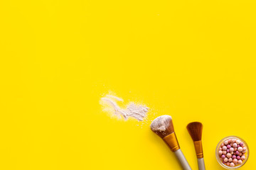 Instruments for make up with brushes, blusher on yellow background top view mock up