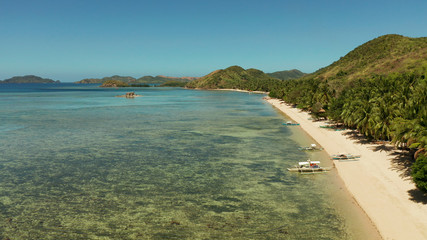 Fototapeta premium Aerial drone small island group in province of Palawan. Busuanga, Philippines. Seascape, islands covered with forest, sea with blue water. tropical landscape, travel concept