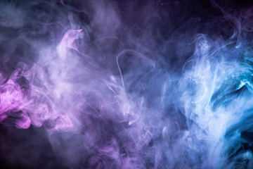 Abstract colorful smoke on black background .