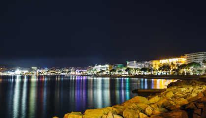 Fototapeta na wymiar Night view Cannes, Cote d'Azur, France, South Europe. Nice city and luxury resort of French riviera. Famous tourist destination with nice beach and Promenade de la Croisette on Mediterranean sea