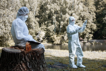 Ecological problem. Pollution. Examine oxygen. Scientist in protective mask and suit taking water...
