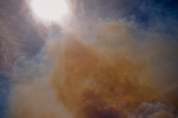 Smoke drifting in front of sun