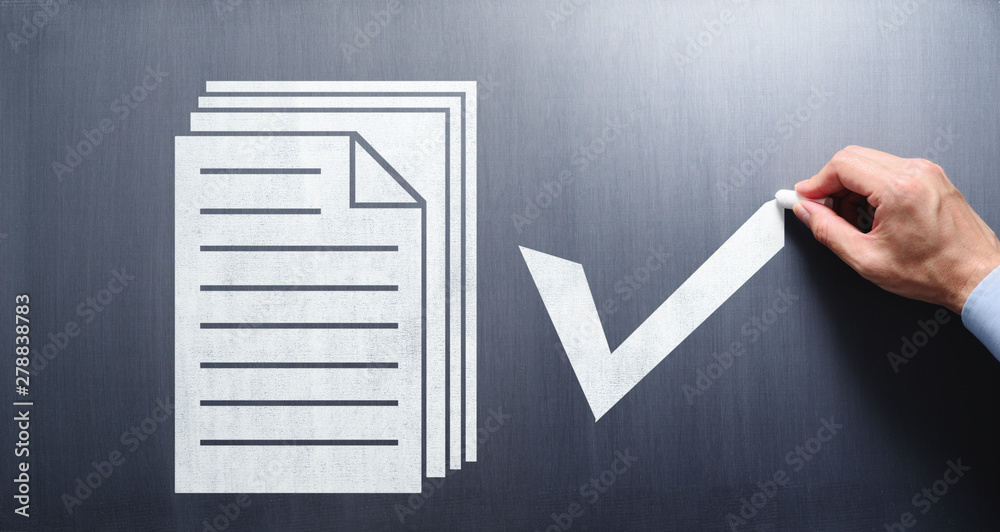 Poster document management concept. businessman drawing documents and check mark on chalkboard.