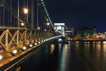 Fototapeta premium Night view of Budapest. Panorama cityscape of famous tourist destination with Danube and bridges. Travel illuminated landscape in Hungary, Europe.