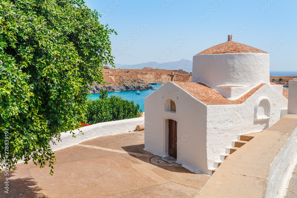 Wall mural sea skyview landscape photo bay and orthodox church in lindos on rhodes island, dodecanese, greece. 