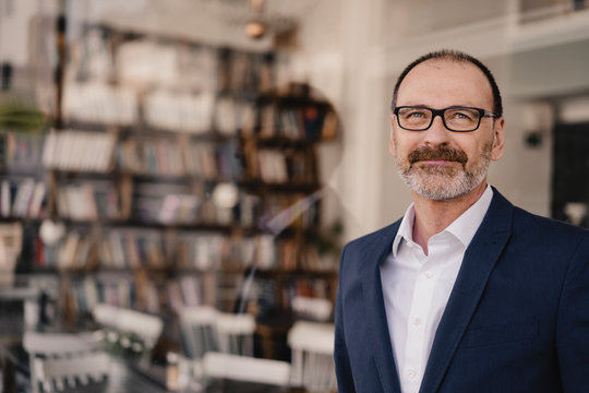 Portrait of confident mature businessman in a cafe