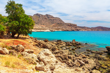 Sea skyview landscape photo near Agia Agathi beach and Feraklos castle on Rhodes island, Dodecanese, Greece. Panorama with sand beach and clear blue water. Famous tourist destination in South Europe