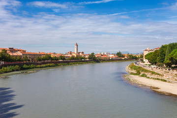 Fototapeta na wymiar Panoramic cityscape aerial view on Verona historical center, bridge and Adige river. Famous travel destination in Italy. Old town where lived Romeo and Juliet from Shakespeare story