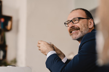 Portrait of smiling mature businessman in a cafe