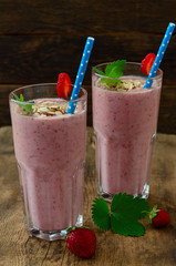 Organic berry smoothie with oatmeal on a dark background t
