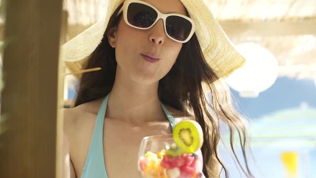 Happy young woman having vacations at the beach