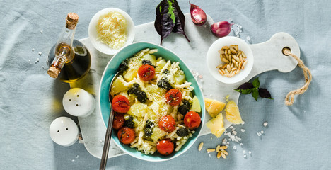 banner of Italian pasta trofie with potato, fried cherry tomatoes and basil pesto. healthy traditional cuisine