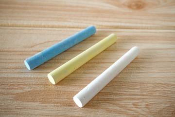 Obraz premium three chalk on wooden background