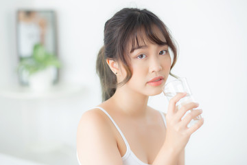 Beautiful portrait young asian woman caucasian smiling with nutrition thirsty and drinking glass of water mineral with fresh and happy, asia girl diet for healthy care and wellness, lifestyle concept.