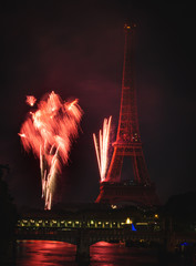 France celebrating Independence day Bastille day in Paris near Eiffel tower with fireworks. Seine river, pont du bir-hakeim, and railway captured in one frame with the Eiffel tower and the fireworks.