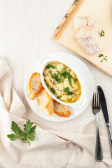 Cod casserole with mussels, creamy gravy, parmesan cheese and provencal herbs, served with french baguette and garlic oil