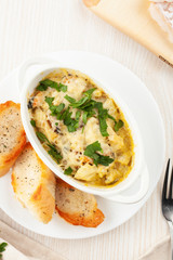 Cod casserole with mussels, creamy gravy, parmesan cheese and provencal herbs, served with french baguette and garlic oil