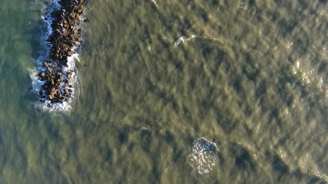DIRTY SEA AND CLIFFS FROM THE AIR