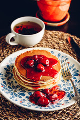 Obraz na płótnie Canvas Stack of pancakes with dogberry jam