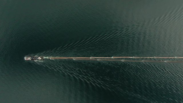 Top Down Aerial Drone Shot of Canadian Logging Tug Boat Pulling Logs & Timber Through Shuswap Lake, British Columbia, Canada. Logging Industry Forestry 