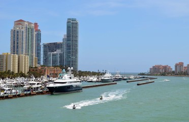 Fototapeta na wymiar Luxury Condominium Towers Overlooking Luxury Yachts moored at a marina in Southeast Florida