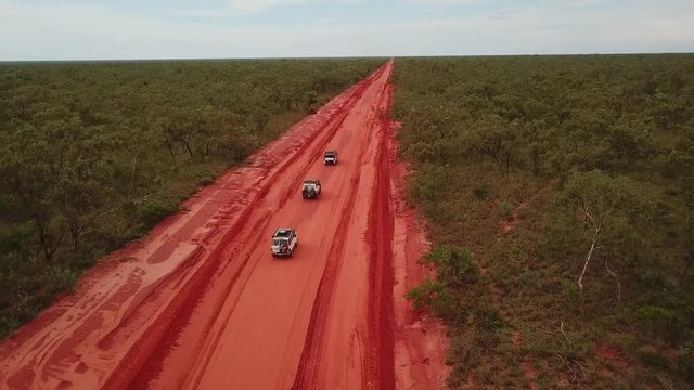 Aerial: Drone Shot Tracking Three 4x4 Vehicles Driving In Convoy On The Red Dirt Cape Leveque Road Near Broome, Western Australia