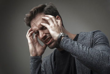 Young guy having a migraine
